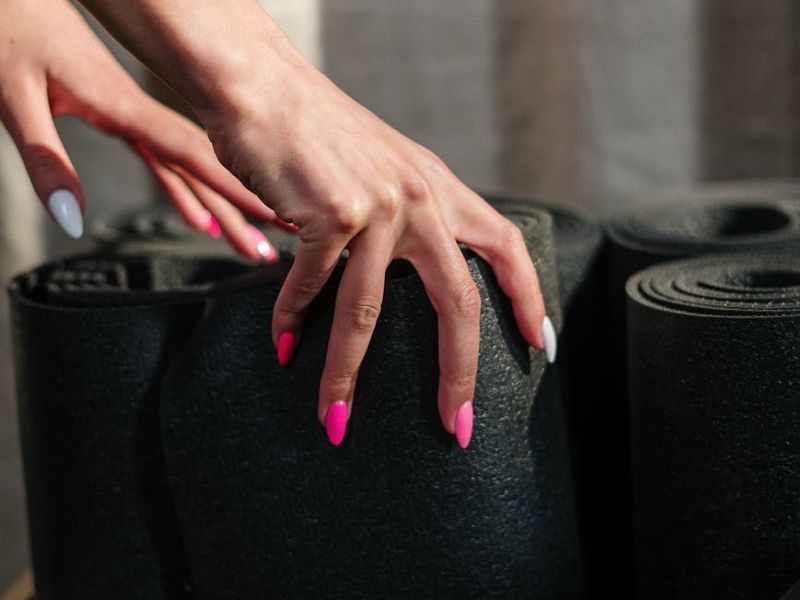 Detailed close-up of a yoga practitioner's hands on a mat